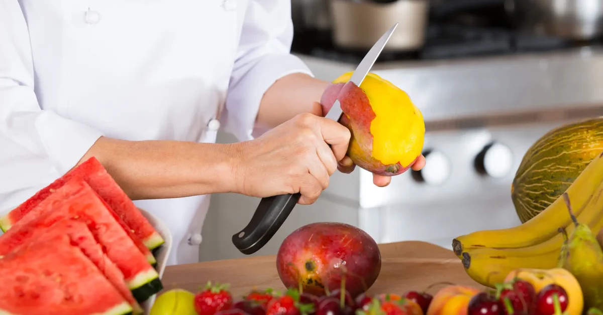 Chef cutting mangos.